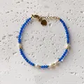 Handmade blue faceted stone and freshwater pearl choker necklace detail on stone surface - Bracelet Style 21 (17+3cm)