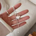 Elegant silver brushed heart pendant necklace with long tassel and ball detail decoration - Brushed Heart Style