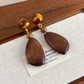 Detailed view of vintage wood teardrop earrings featuring amber-tone beads and ethnic charm. - Teardrop Geometric Style (27605A)