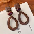 Detailed macro shot of vintage wooden teardrop earrings with a natural brown grain finish - Hollow Teardrop Geometric Style (28275)