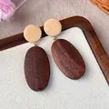 Close-up of vintage wooden geometric earrings featuring natural wood grain texture - Brown Oval Wood Style (28270B)