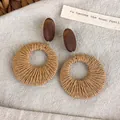 Retro wooden and woven geometric earrings in brown and tan tones on beige linen - Round Straw Woven Geometric (28420F)