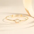Elegant gold adjustable bangle bracelet featuring a crystal-encrusted letter C design - Style C