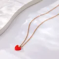 Detail view of a dainty gold necklace featuring a polished red heart pendant design. - B03 Rose Gold