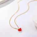 Close-up of a delicate gold chain necklace with a vibrant red heart oil-drop pendant. - B03 Gold