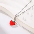 Detailed macro view of a red drip oil heart pendant on a silver titanium steel chain - B03 Silver