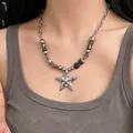 Detailed view of a silver star pendant necklace with punk metal beads on a model. - Large Star (L0099)