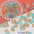 High-quality detailed view of 18x13mm blue and amber gradient glass flower beads - Daybreak Gradient (L105# Relief Tag)