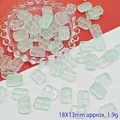 Detail view of 18x13mm rectangular pale green glass beads with floral relief - Light Green (L106# Relief Tag)
