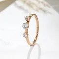 Close-up of rose gold titanium steel ring featuring three brilliant vertical clear stones - US 5 / Rose Gold (J109)