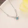 Elegant silver butterfly necklace featuring a blue heart-shaped planet crystal pendant. - Blue Zirconia Heart Planet (N-758)