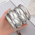 Chunky silver-toned polished metal bangle set featuring a high-gloss mirror finish - 6649902HB