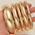 Set of six gold-toned polished metal bangles in varying widths for women's fashion - 6780701HB