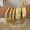 Bold and chunky gold bangle set featuring hammered and polished smooth textures for women - 6774901HB