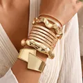 Statement oversized gold metal cuff and multi-style textured bangle bracelet set - 6794701HB