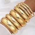Trendy set of glossy gold-colored chunky metal bangles in various widths for women - 6796201HB