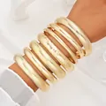 Chunky gold-tone stackable bangle set featuring various textures and smooth finishes - 6795901HB
