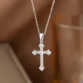 Detailed macro view of a silver cross pendant necklace with sparkling cubic zirconia stones - Full Zirconia Prong-Set Style (8194) / Steel
