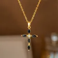 Close-up detail of a elegant gold-tone cross necklace set with black marquise zircons - Black Marquise Zirconia Cross (8419) / Gold