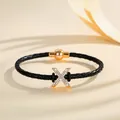 Elegant black braided leather bracelet with gold letter X rhinestone charm and magnetic clasp - Letter X (PSL221--X)