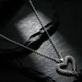 Detailed macro view of vintage silver centipede heart pendant on dark slate stone - Heart-Shaped Centipede Necklace (0619) / Silver