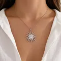 Detailed view of the sun moon and star pendant necklace with rhinestones on model - Cross Chain Sunflower Necklace / White Gold