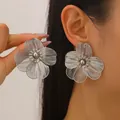Large silver hollow flower stud earrings for women with intricate petal design - Stud Earrings (05)