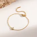 Elegant 18K gold plated titanium steel necklace featuring a mini zircon four-leaf clover. - Mini Four-Leaf Clover Bracelet (XKB0311) / Gold