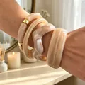 Chunky acrylic bracelet set with marble texture and gold accents in cream beige - Spliced Acrylic Bangle Set (6799701) / Four-Piece Set / Cream Marble/Gold