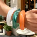 Set of three colorful chunky acrylic bangles in marbled white, green and vibrant orange - Irregular Streamlined Bangle Set (6803601) / Three-Piece Set / Ivory White/Emerald Green/Orange Red