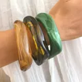 Statement irregular acrylic bangles set in amber and marbled green translucent finish - Translucent Fluid Texture Bangle Set (6803701) / Three-Piece Set / Amber/Olive Green/Forest Green