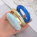 Set of 3 chunky acrylic bangles in gold, royal blue, and marbled sky blue finishes - Modern Minimalist Chunky Bangle Set (6788501) / Three-Piece Set / Gold/Dark Blue/Light Blue