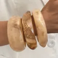 Elegant set of chunky acrylic bangles with marble textures and shimmering gold foil details - 3-Piece Irregular Open Bangle Set (6705105HB) / Yellow Marble Combo