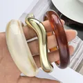 Set of three acrylic and gold irregular bangles for women in cream, amber and gold - Irregular Streamlined Bangle Set (6769101HB) / Amber and Milky White Combo