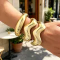 Set of three irregular golden acrylic bangles with a wavy and smooth polished design. - Gold Irregular Wave Open 3-Piece Bangle Set (6800801HB) / Gold