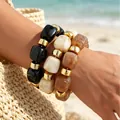 Set of three acrylic irregular bead bracelets in black, beige, and marble tan colors. - Beaded Bracelet Set (6768101) / Three-Piece Set / Black/Beige/Brown Marble