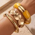 Exaggerated gold and yellow acrylic chunky bangle set with textured disc details - Bamboo Style and Hammered Bangle 3-Piece Set (6811702HB) / Gold Yellow