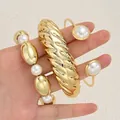 Chunky golden acrylic bracelet set with pearl details and irregular ribbed cuff design - Vintage Wave Open Bangle 3-Piece Set (6795801HB) / Bright Gold with Artificial Pearl