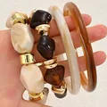Stylish chunky acrylic resin bangle bracelet set featuring marble and amber stone textures - Irregular Resin Bead and Bangle Set (6748301) / Three-Piece Set / Amber and Cream White Combo