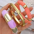 Chunky acrylic and gold-toned metal bracelet set in purple and coral tones - Acrylic Segments and Metal Ring Bangle Set (6789501HB) / Three-Piece Set / Purple and Coral Combo