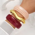 Elegant set of chunky acrylic and wavy gold-toned metal bangle bracelets for women - Exaggerated Irregular Wave Bangle Set (6807901) / Three-Piece Set / Pink Gold Wine Red Combo
