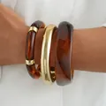 Stacked acrylic amber and gold bangles set for women's stylish hand jewelry - Irregular Amber Pattern Bangle 3-Piece Set (6787402) / Gold and Amber Combo