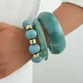 Set of three statement acrylic bracelets featuring blue marble bangles and gold bead accents - Teal Marble Pattern Bangle 3-Piece Set (6762101HB) / Blue and Gold Combo