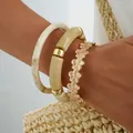 Bohemian acrylic bracelet set featuring gold floral bangle and beige marble resin cuffs - Simple Natural Bohemian Bangle 3-Piece Set (6789401HB) / Gold and Beige Combo