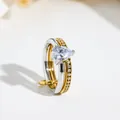 Detailed view of dual-band stainless steel ring featuring a pear-cut clear gemstone - US 7 / Pear Stone Double Loop / Gold & Silver Gradient