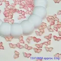 Close-up of pink translucent butterfly glass beads for DIY hair accessories. - 15x10mm / Beige/Cream