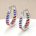 Close-up of silver-toned hoop earrings with red, blue, and white rhinestone rows - Silver