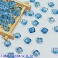 Close-up of 10mm blue glass flower beads, perfect for DIY jewelry and hair accessories - Ink Blue (L343#)