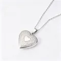 Close-up of silver heart locket necklace with floral engraving and polished center - Floral Heart Locket Pendant (Silver)