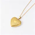 Close-up detail of a gold heart locket necklace with delicate floral engravings. - Floral Heart Locket Pendant (Gold)